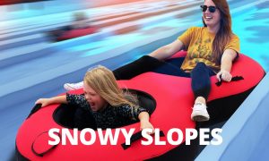 Mother & Daughter In Snow Tube