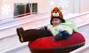 Kid In Snow Tube