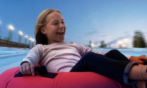 Young Girl Riding In Snow Tube