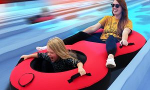 Mother & Daughter In Snow Tube